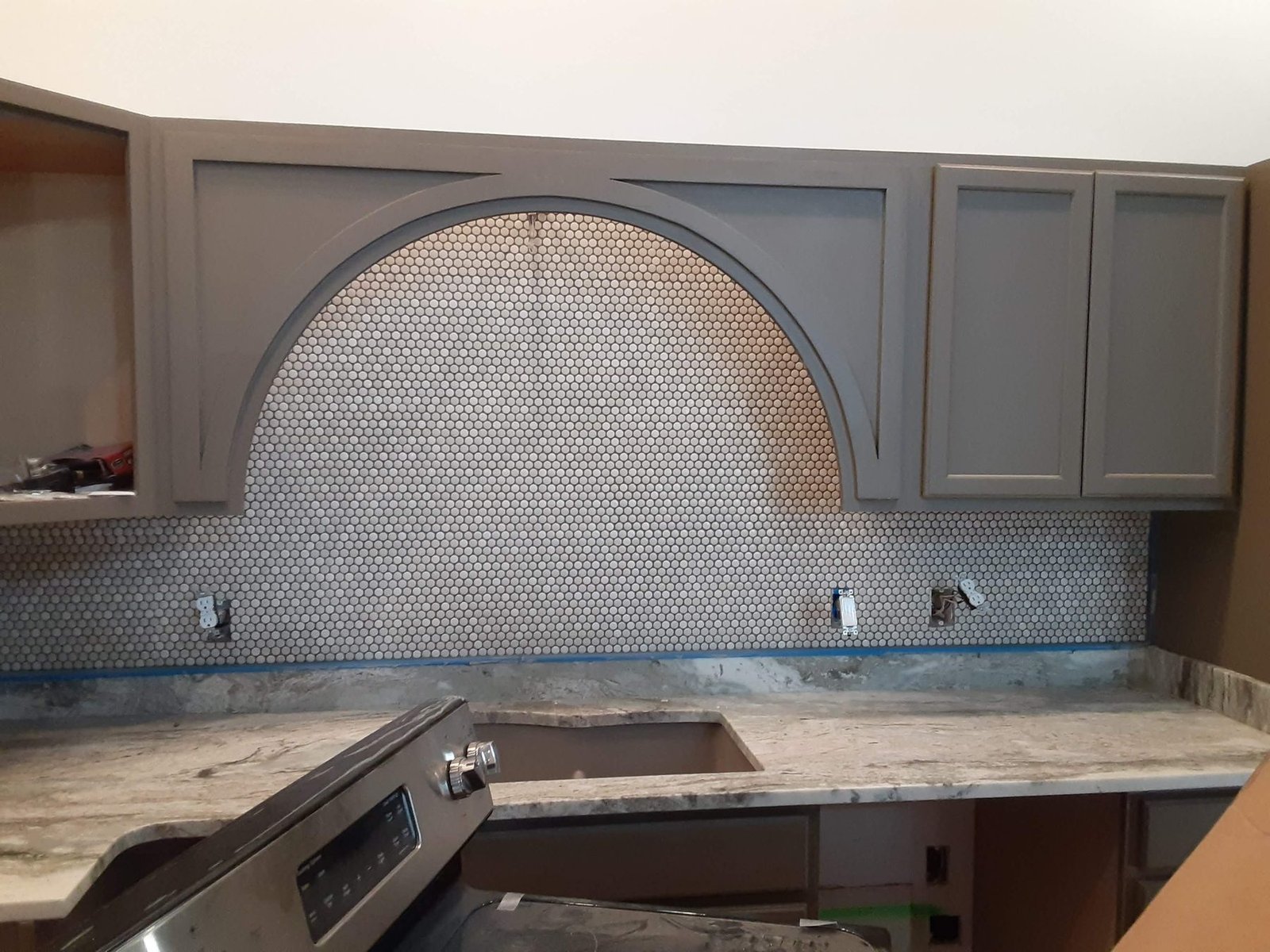 Arched penny-tile backsplash