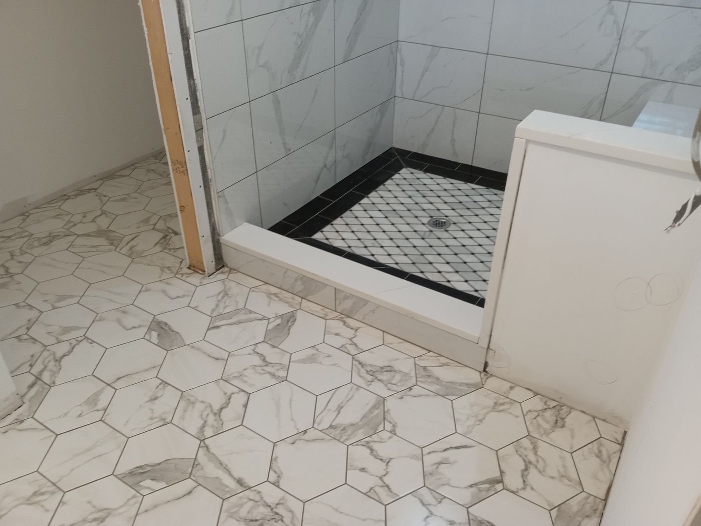 Marble-look hex floor & shower curb