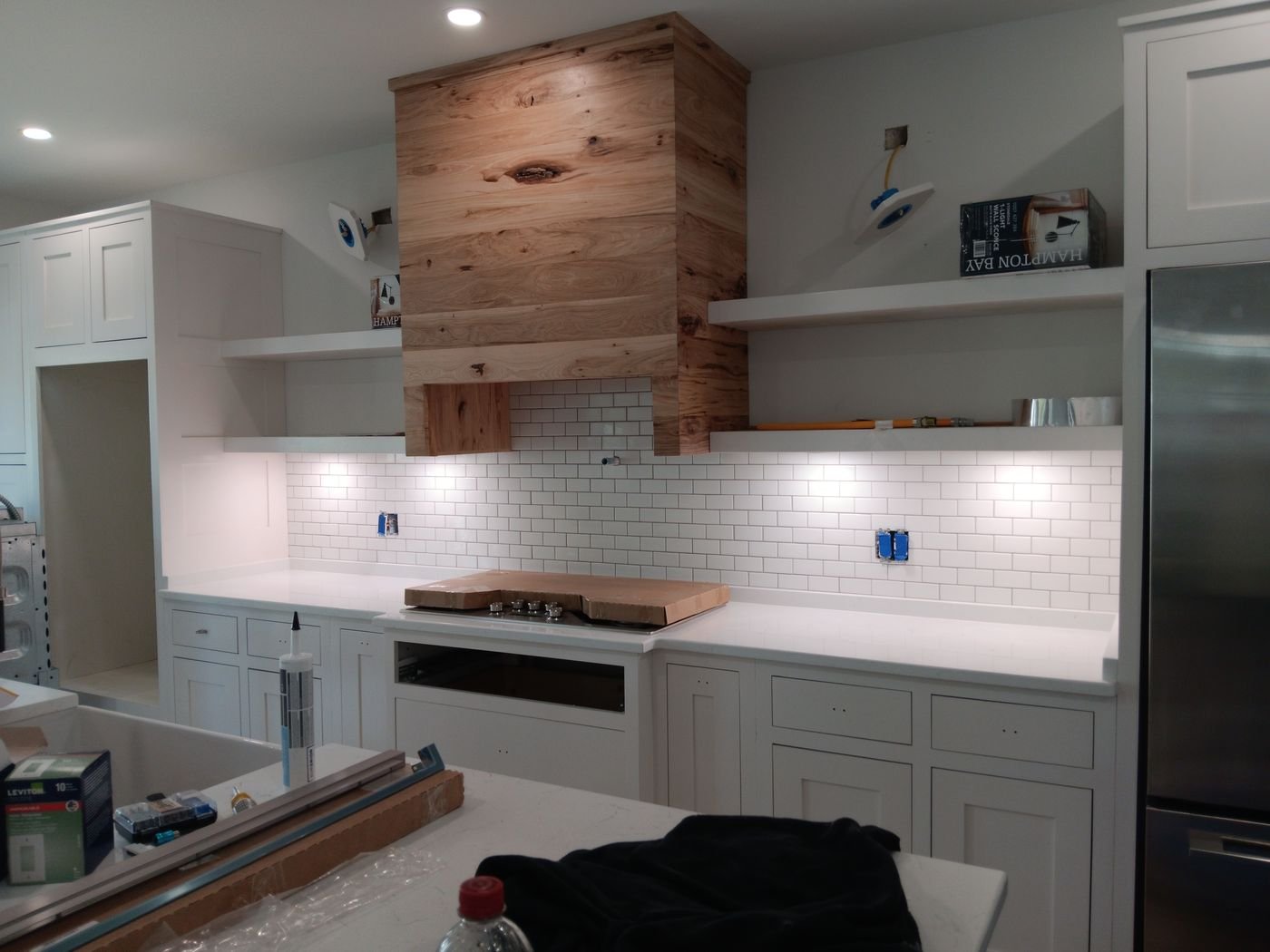 Subway backsplash with wood range hood