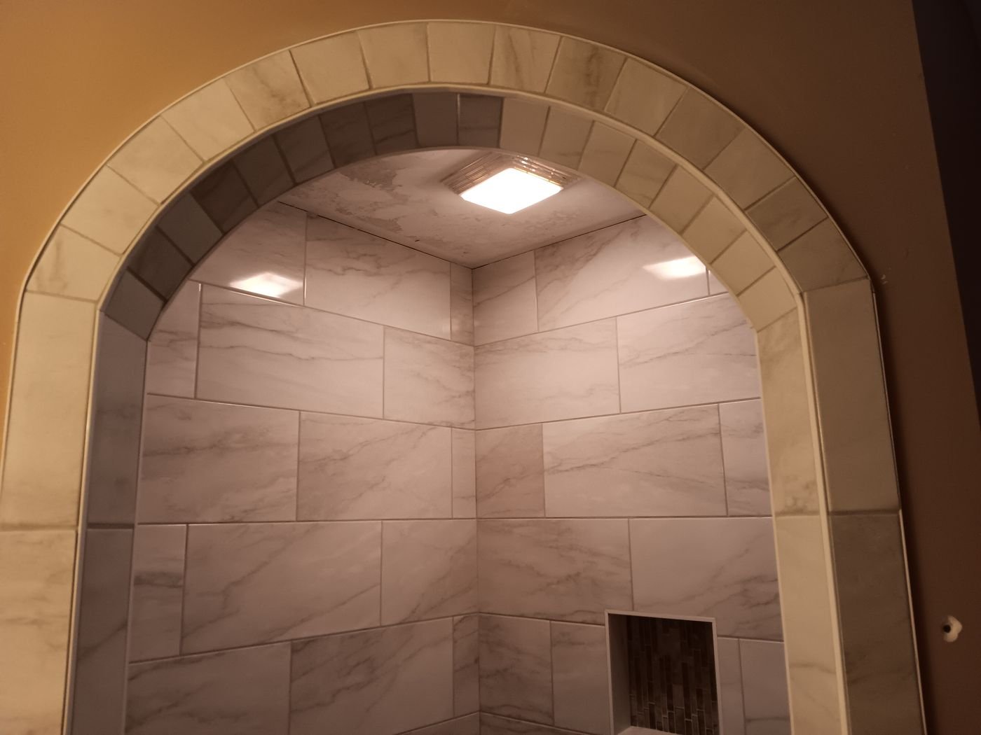 Arched walk-in shower entry