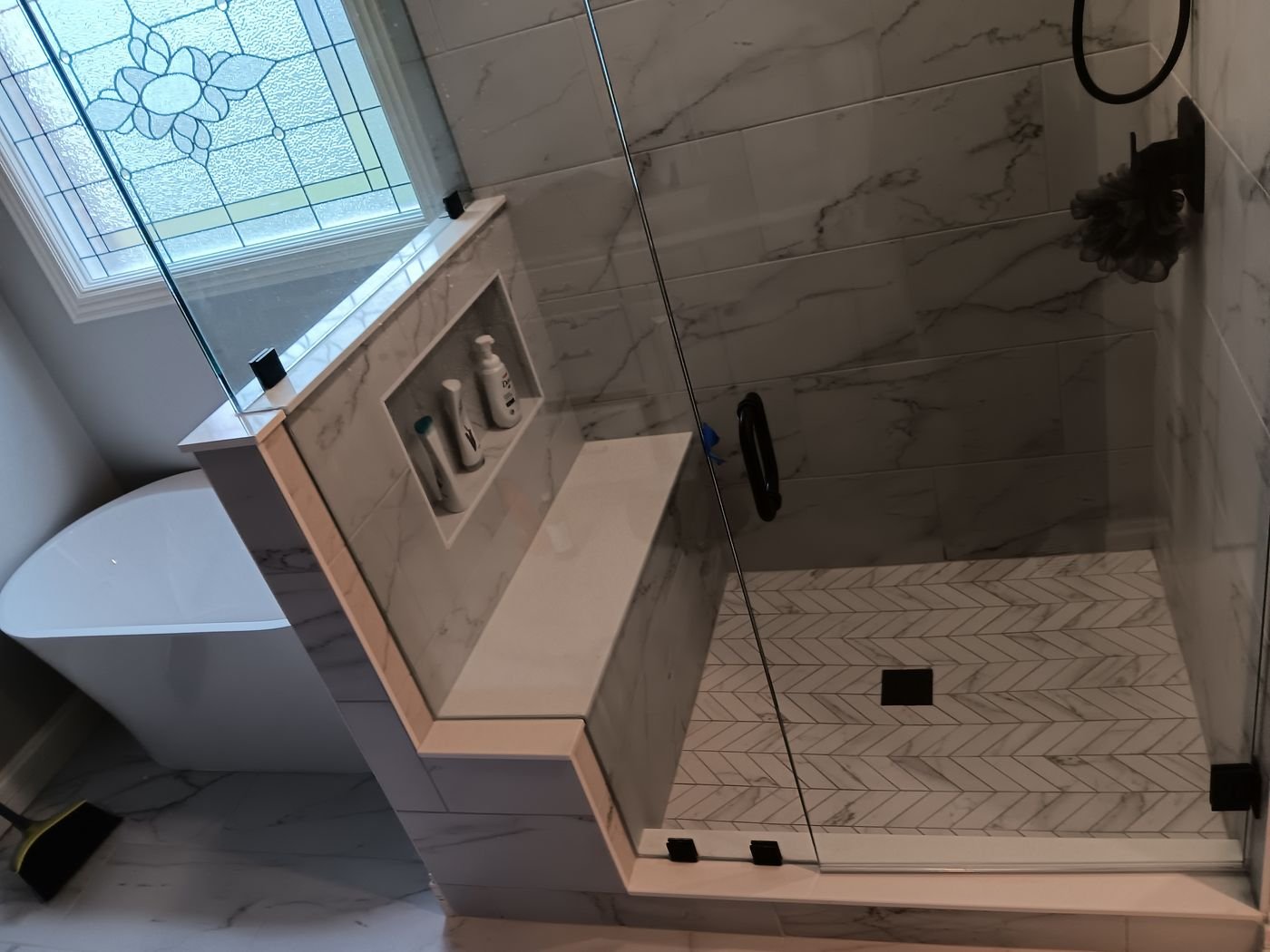 Glass shower with bench & herringbone floor
