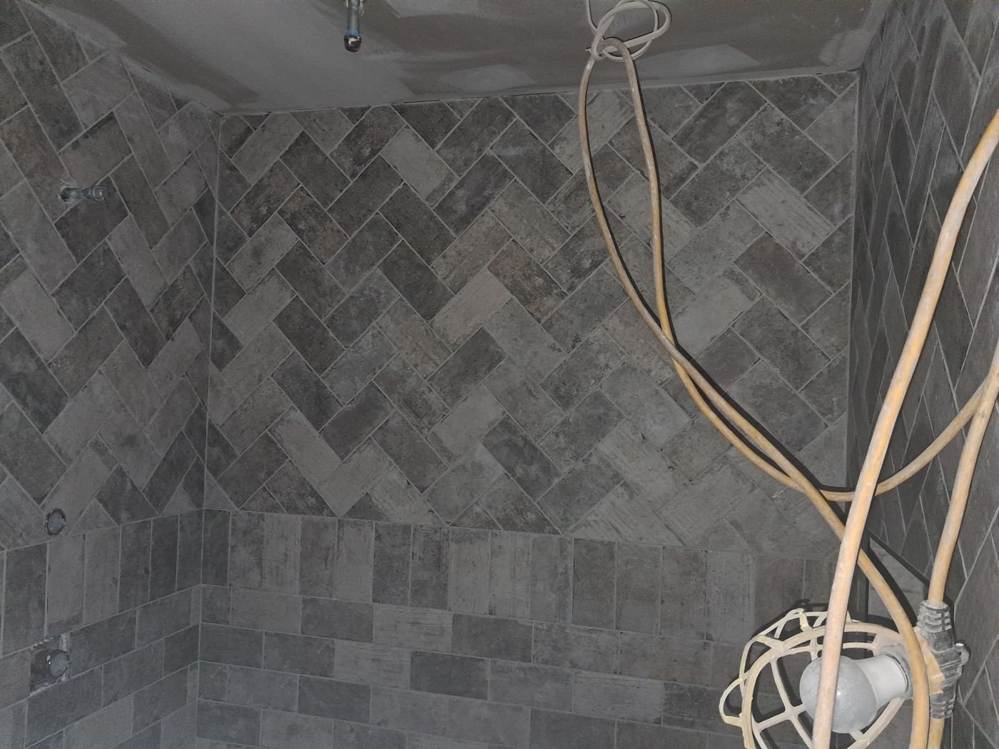Gray herringbone shower wall